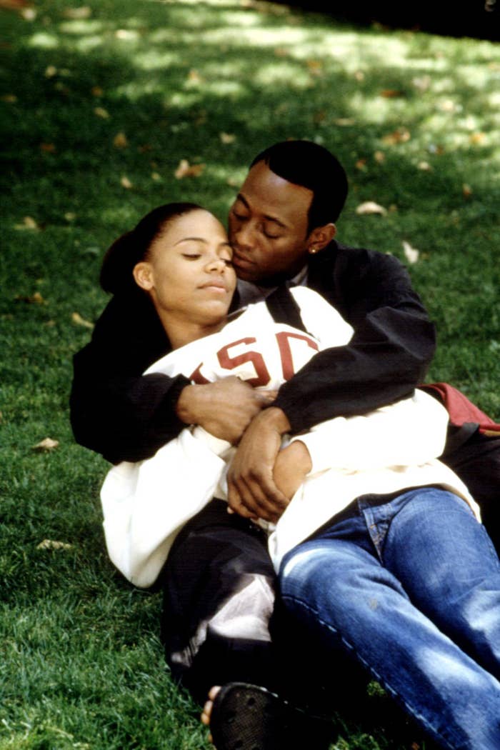 Sanaa Lathan and Omar Epps laying in the grass