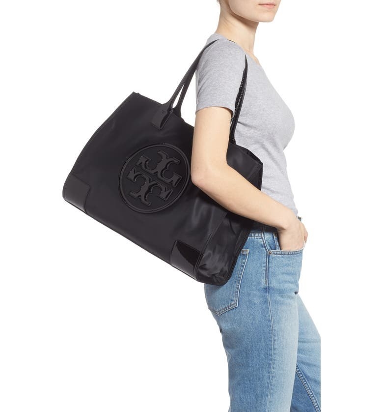 A model with the bag on their shoulder, showing that it comes down to the middle of their hips