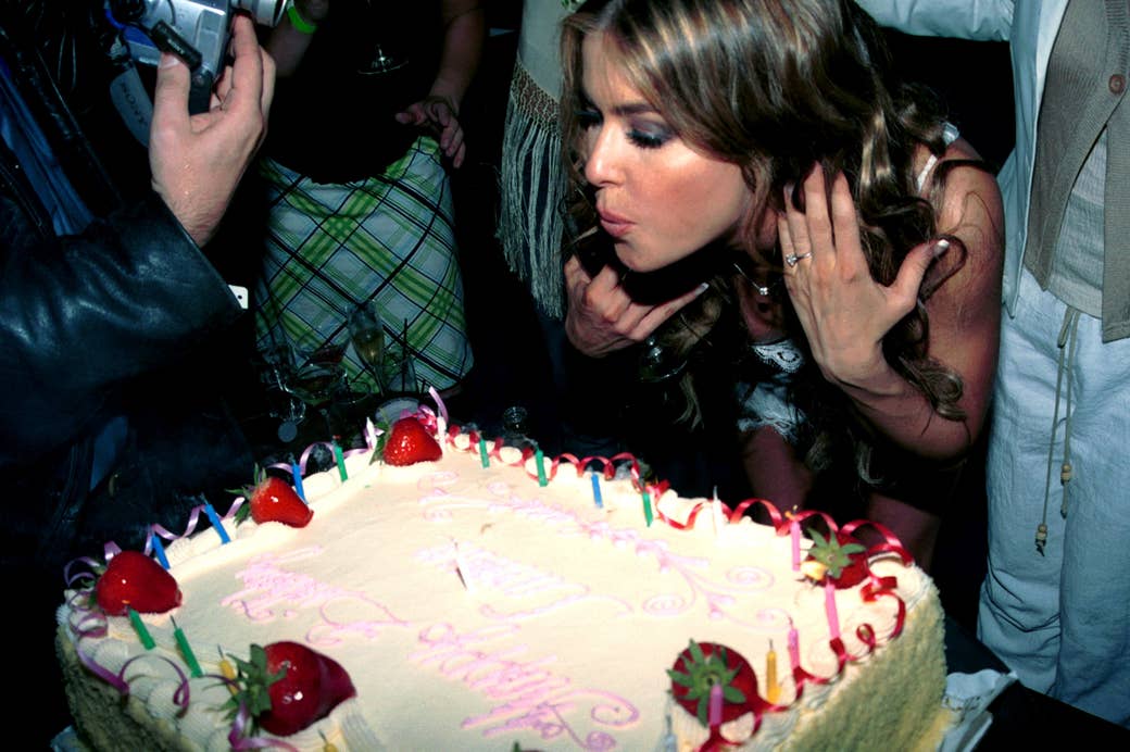 Carmen Electra blowing out the candles on a birthday cake