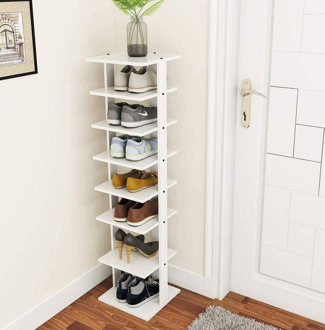 A seven tier simple white standing shoe rack 
