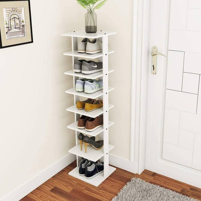 A seven tier simple white standing shoe rack 