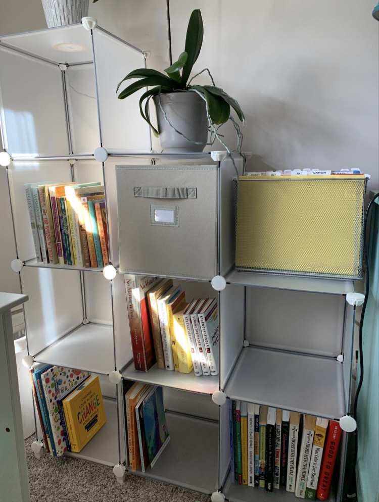 Reviewer's clear box-shaped storage shelving tiered with two boxes, then three, then four