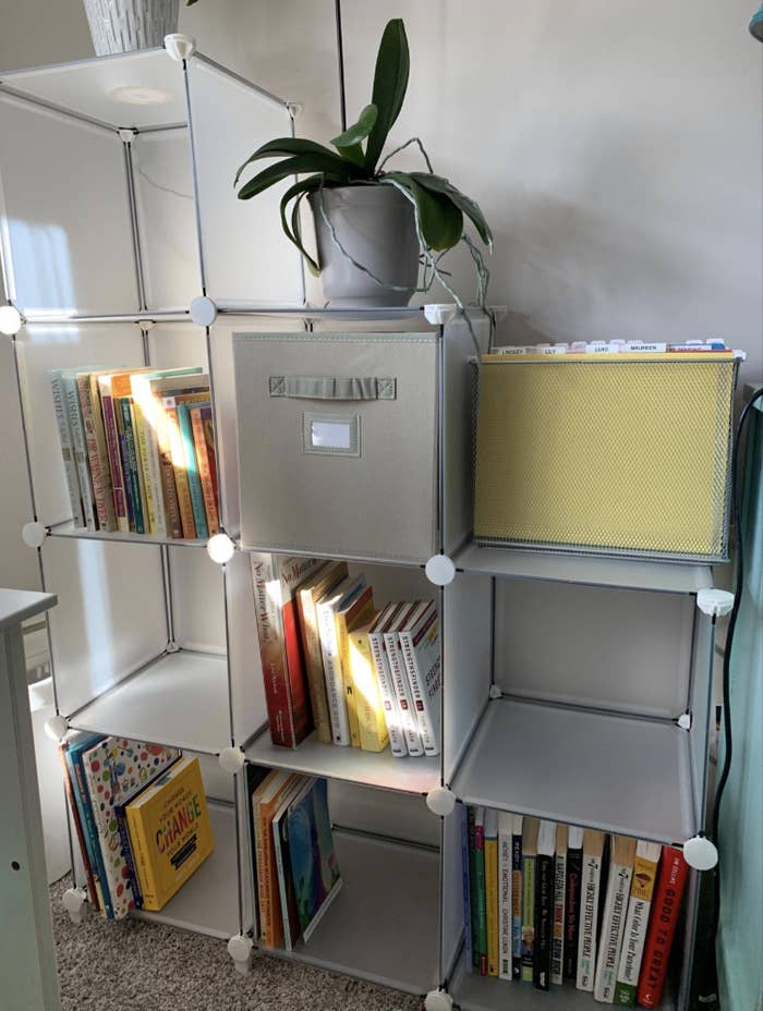 Reviewer image of clear box-shaped storage shelving tiered with two boxes, then three, then four 
