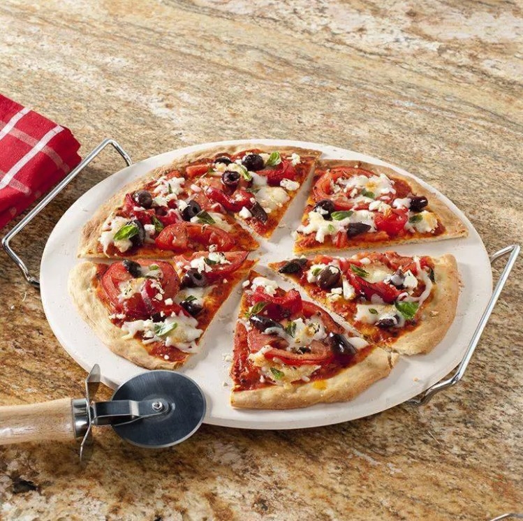 The pizza holder with a pizza on it
