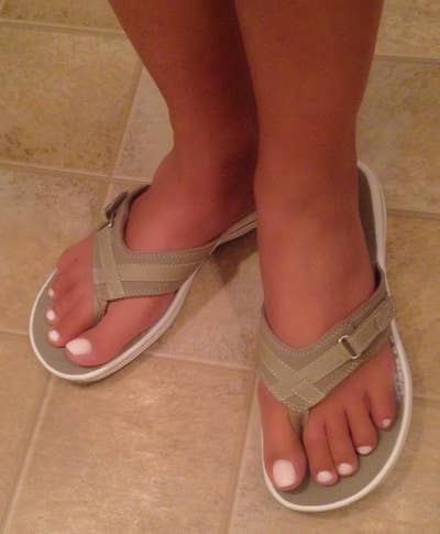 A reviewer photo of someone wearing the flip-flops
