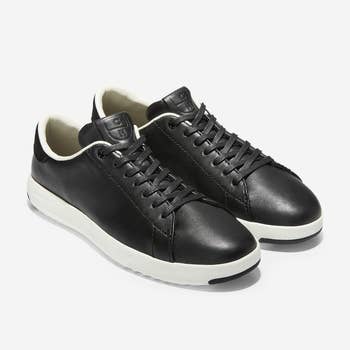 a pair of black leather sneakers with white rubber soles