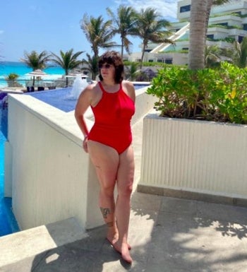 person wearing a red bathing suit at a tropical resort