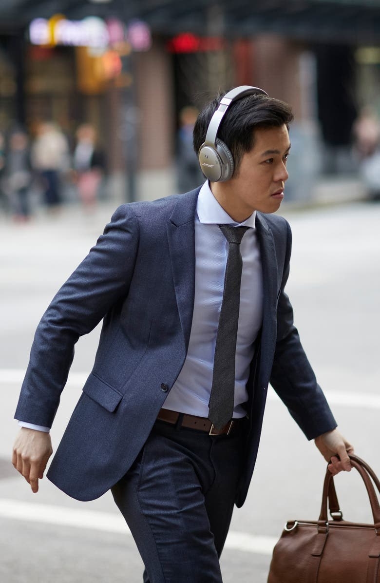 A model wears the headphones while commuting
