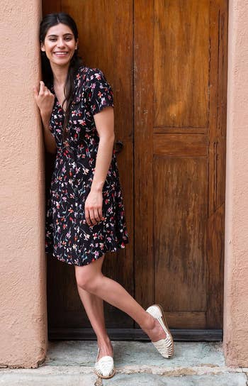 A model wearing a printed dress and the woven sandals in the color 