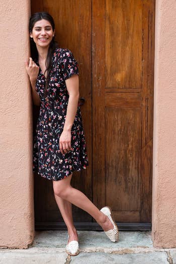 A model wearing a printed dress and the woven sandals in the color 