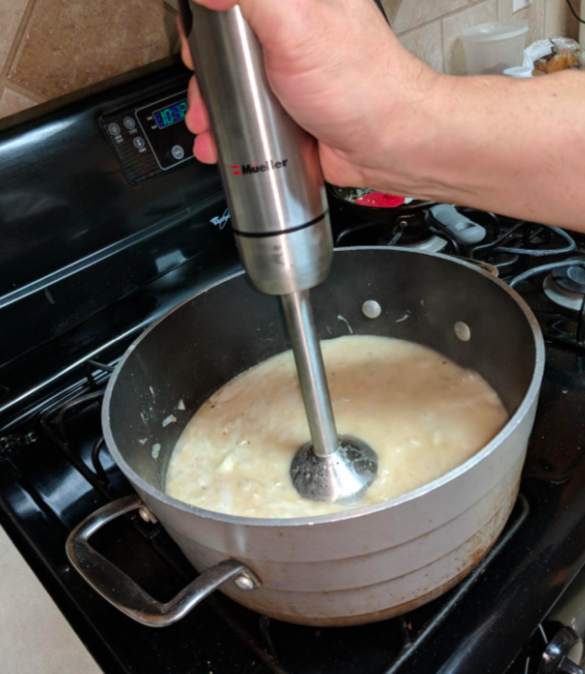Reviewer making soup with the immersion blender