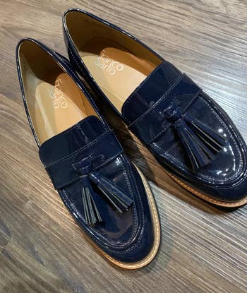 a reviewer photo of the patent loafers with tassel detailing in navy 