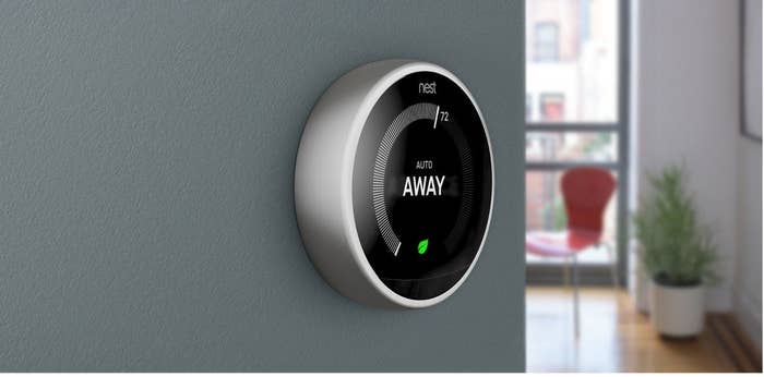 Google Nest thermostat on the wall, set to &quot;Away&quot;