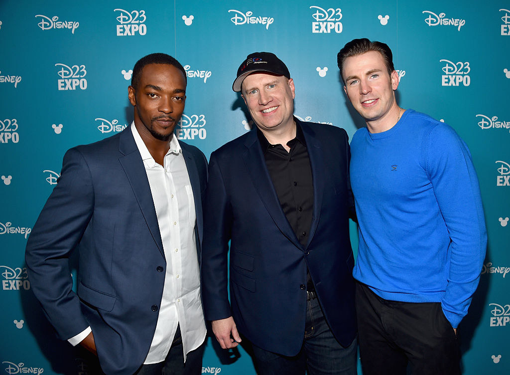 Anthony Mackie, Kevin Feige, and Chris Evans posing together at the D23 Expo