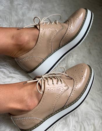 a reviewer photo of a pair of feet wearing the platform oxfords in tan 
