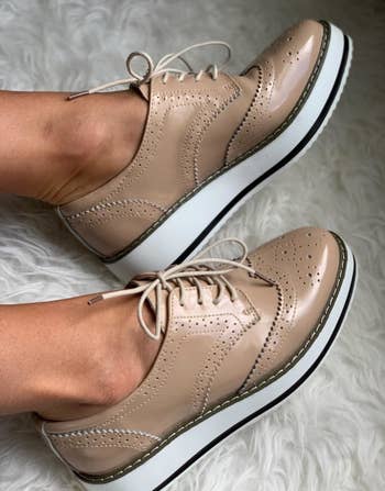 a reviewer photo of a pair of feet wearing the platform oxfords in tan 
