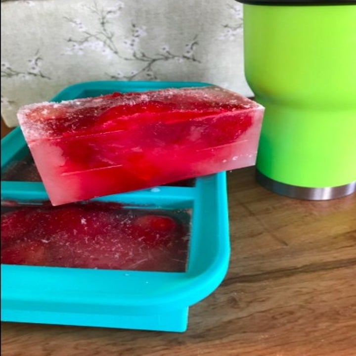 a blue ice tray with huge red ice blocks in it