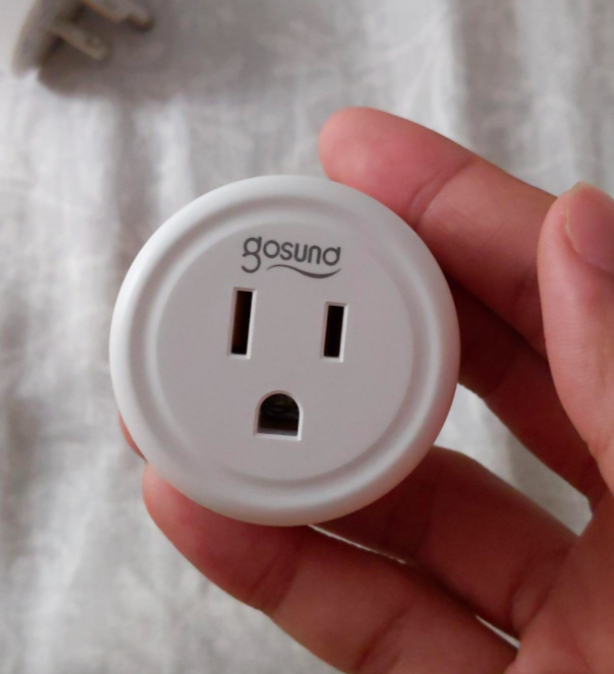 Reviewer holding the smart plug