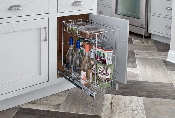 the pull out drawer holding wine bottles and canned goods