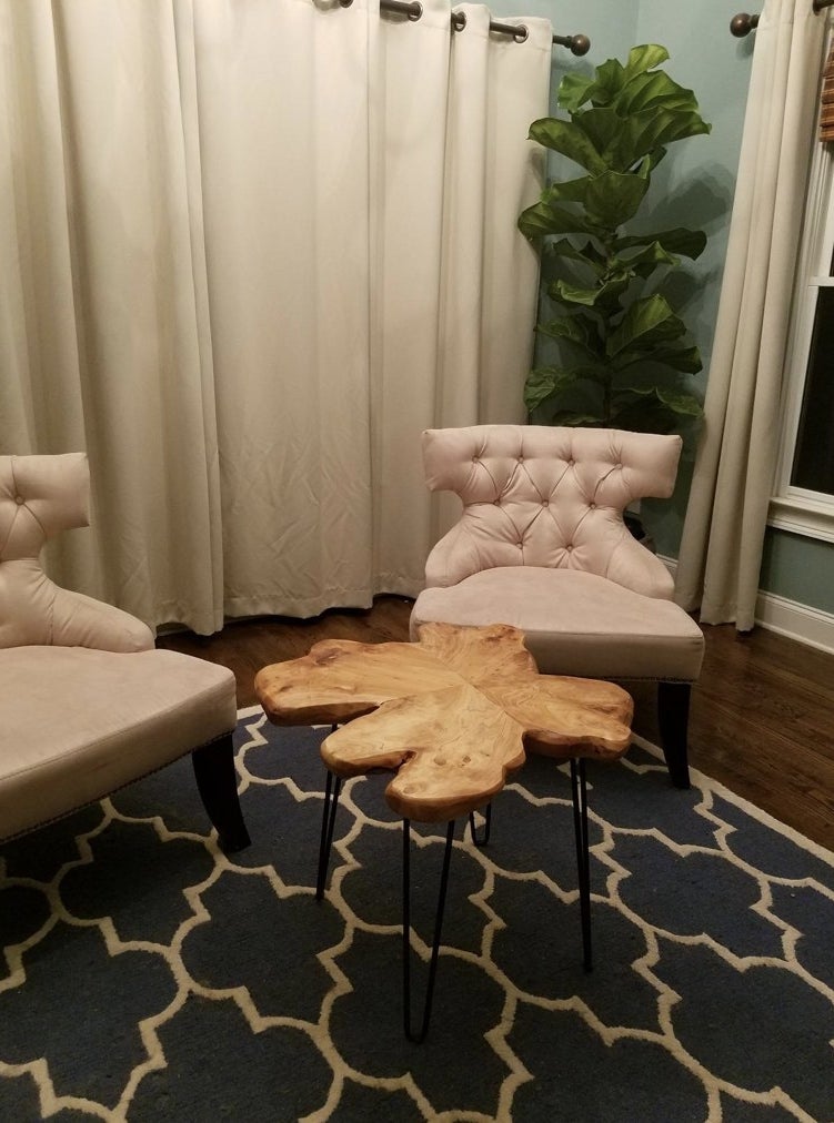 End table sitting in living room with two chairs