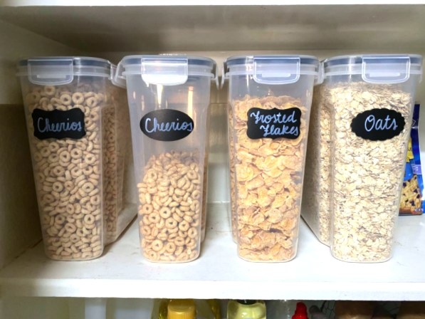 four airtight food storage containers lined up with labels on them