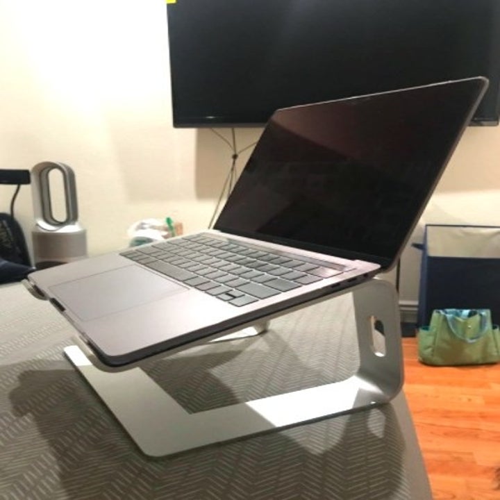 grey laptop on a gray laptop stand