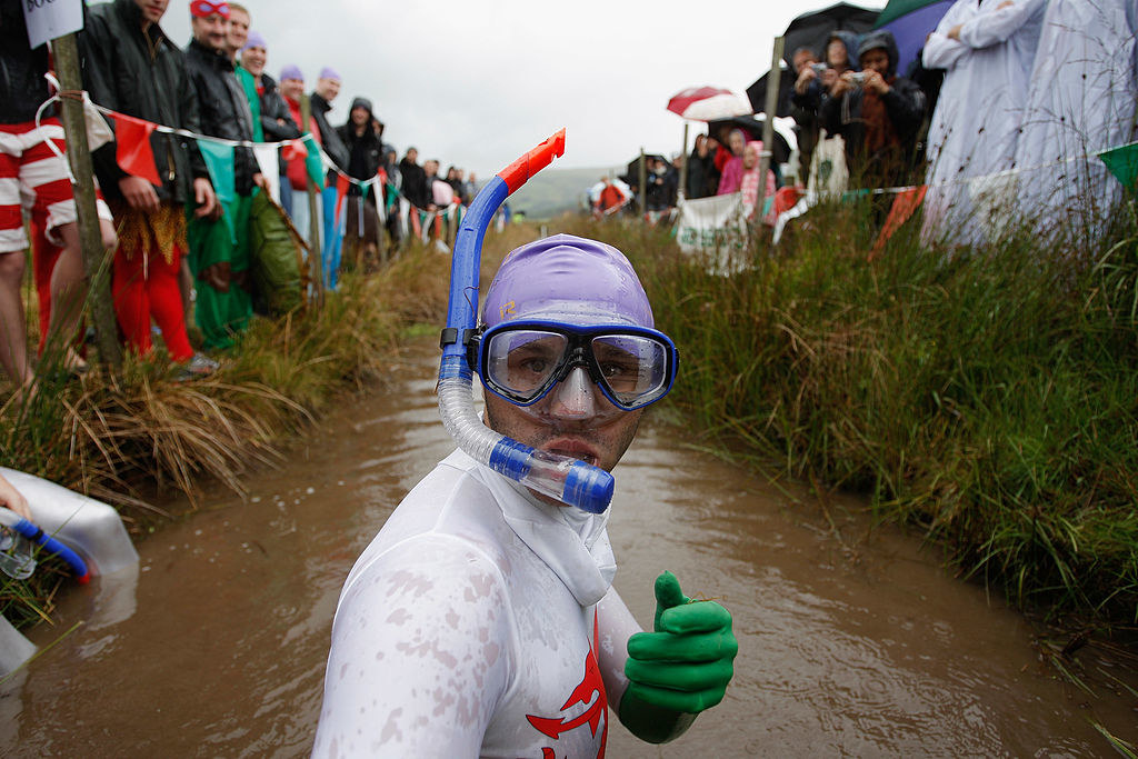 A competitor prepares to snorkle through a muddy bog
