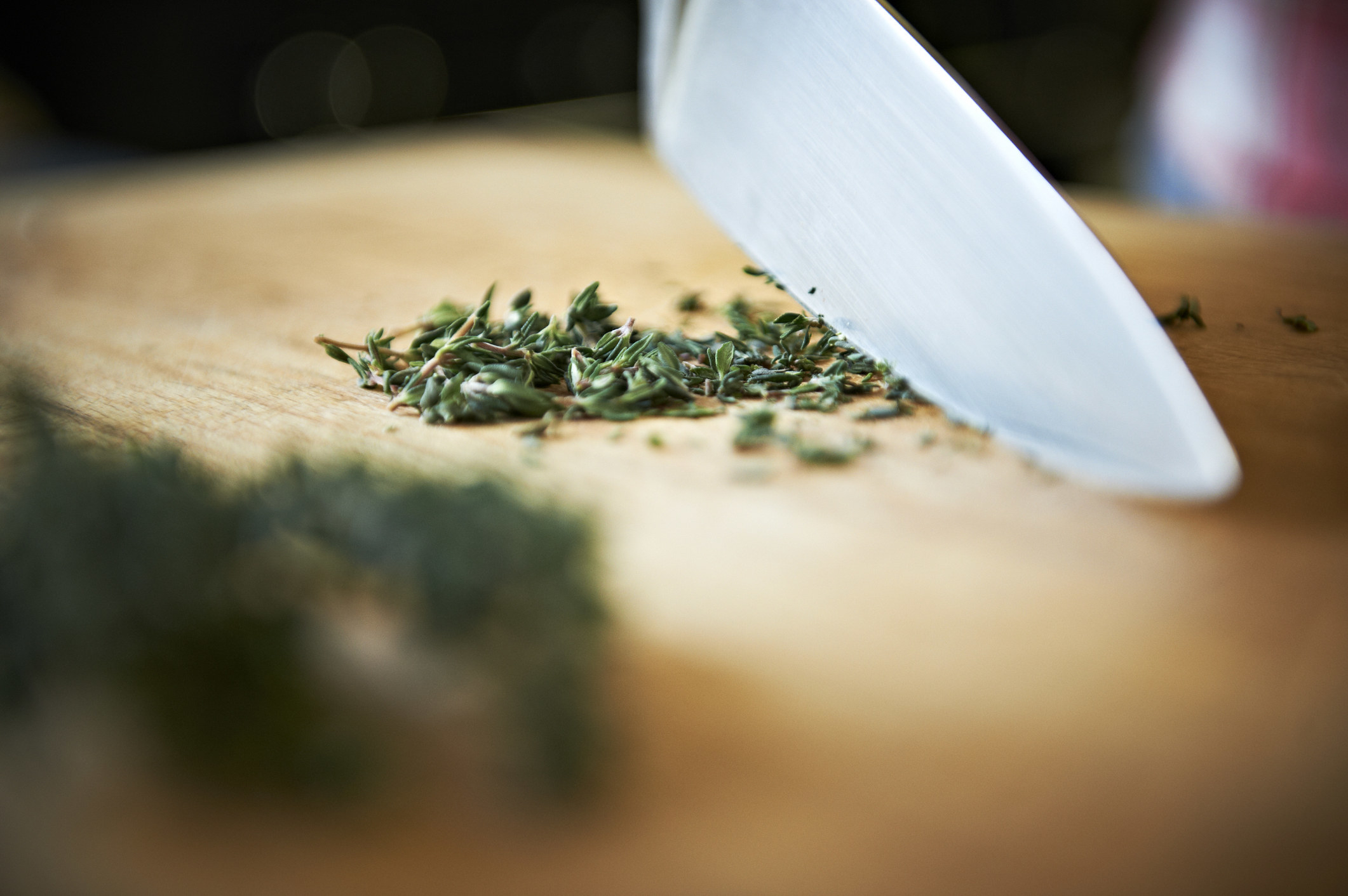 Thinly slicing herbs with a sharp knife.