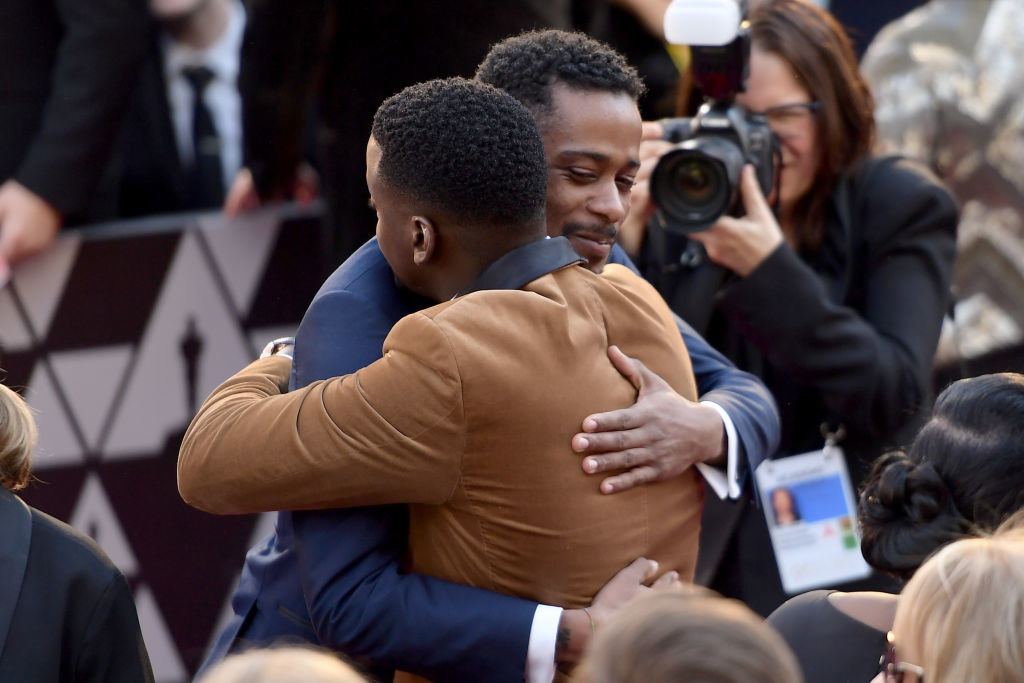 Lakeith Stanfield and Daniel Kaluuya hugging at the 90th Annual Academy Awards 