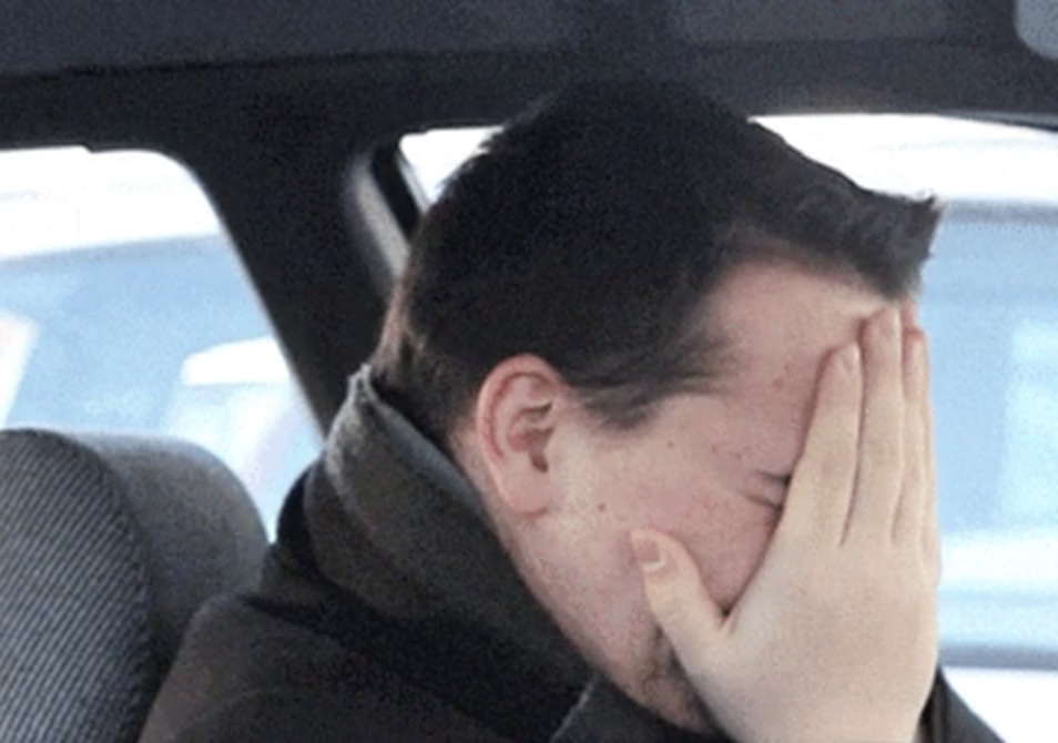 A man cries in the car