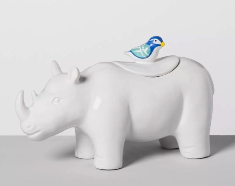 White ceramic rhino shaped cookie jar with colorful bird shaped lid handle