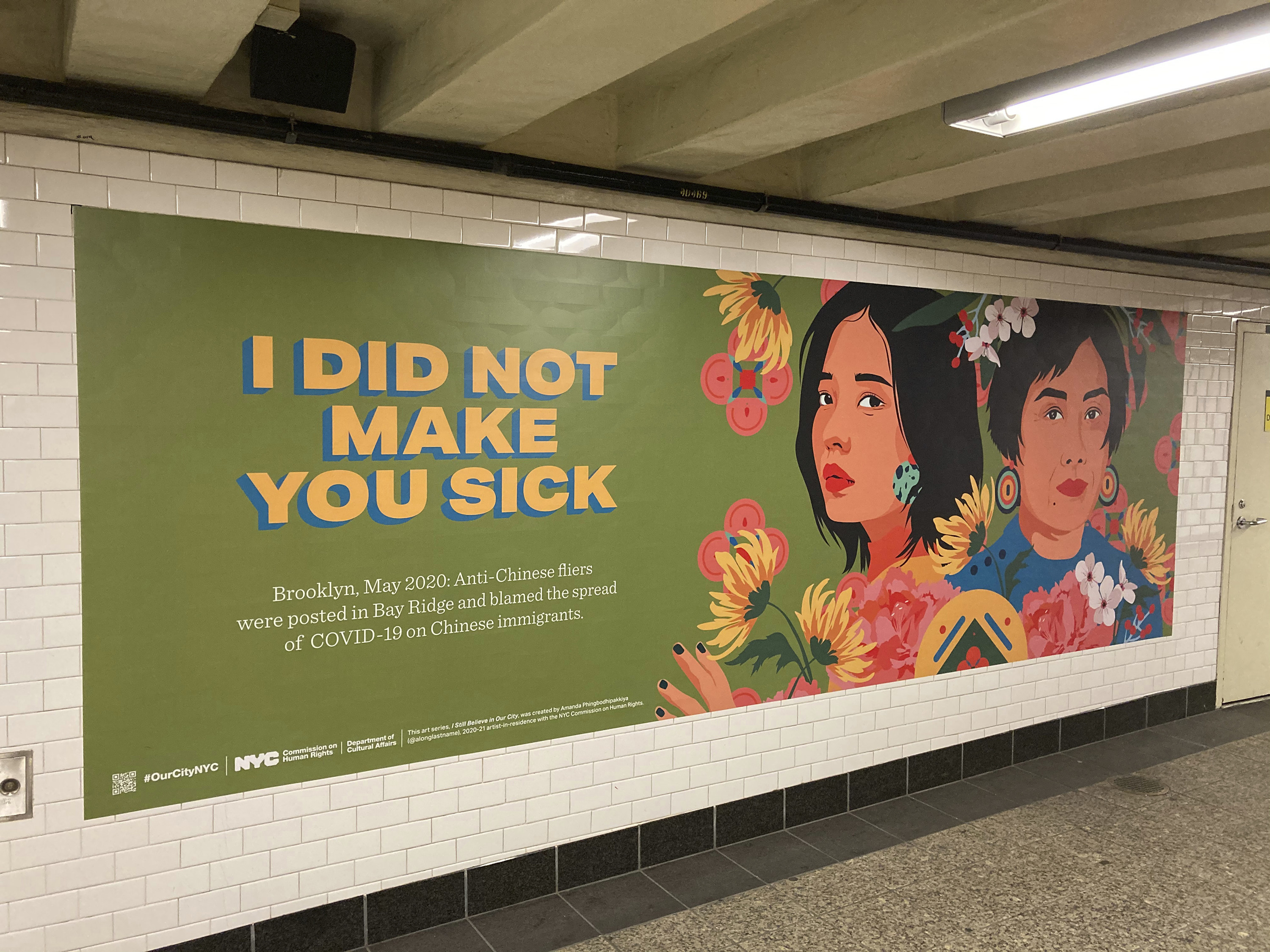 A subway sign shows illustrations of two Asian women with flowers and reads &quot;I did not make you sick&quot;