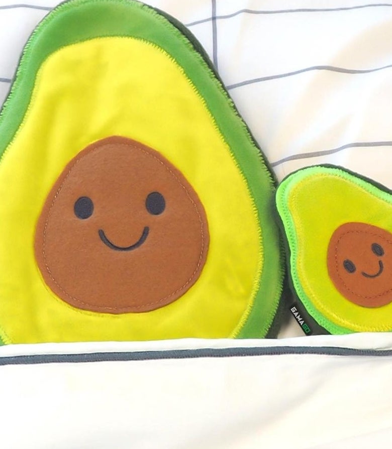 A smiling avocado-shaped heating pad