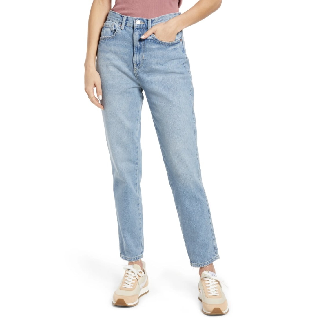 Model is wearing light denim jeans and peach tennis shoes