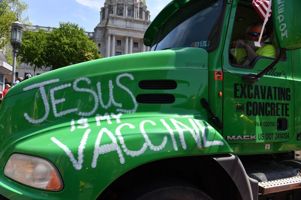 Writing on the side of a truck reading, &quot;Jesus is my vaccine&quot;
