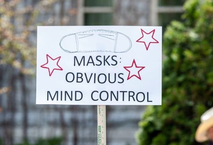 Sign reading, "Masks: Obvious Mind Control"