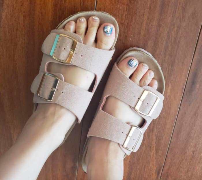 Reviewer wearing the Birkenstock-like sandals in beige