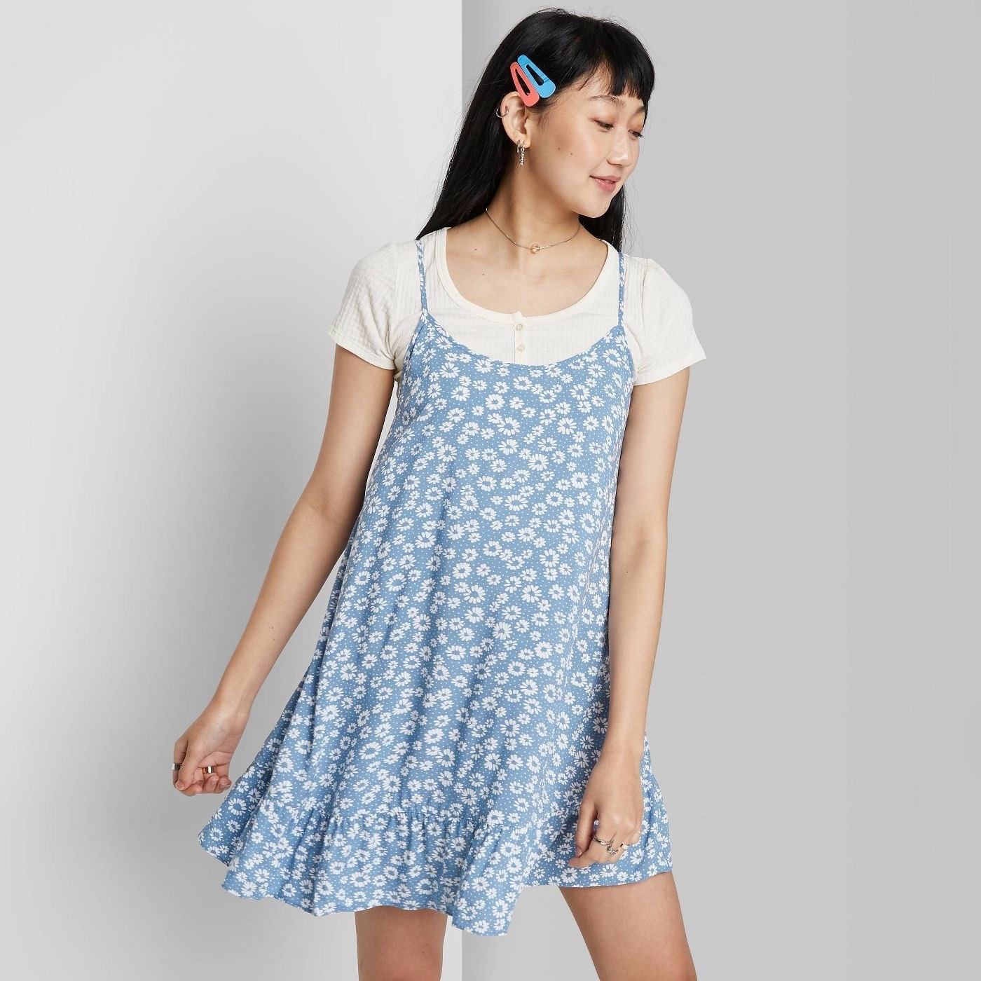 model wearing a blue floral print dress 