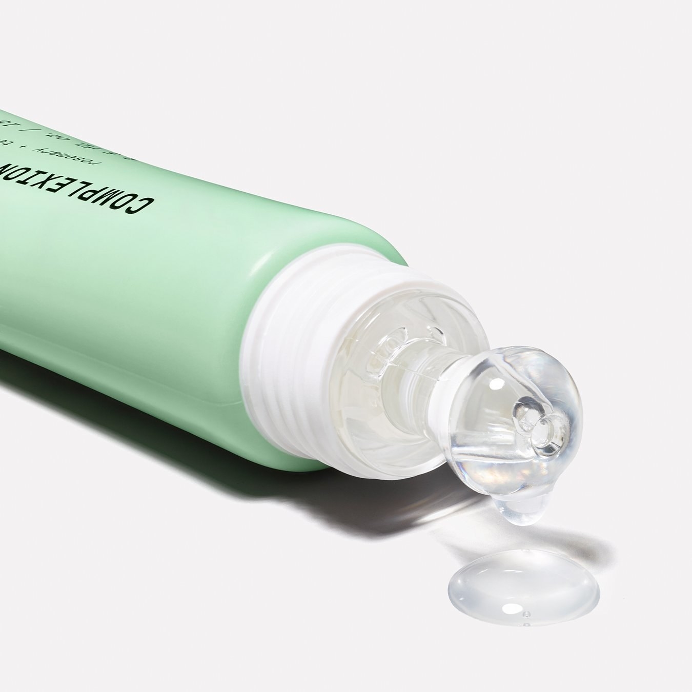 the acne spot treatment in a light green tube