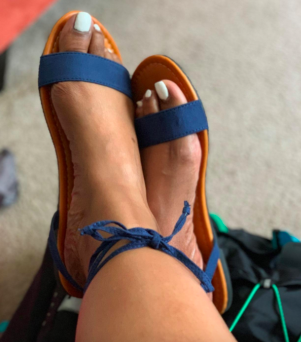 Reviewer wearing the blue strappy sandals