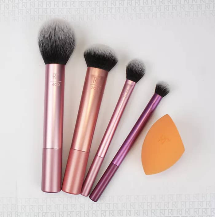 the brush set with purple and pink brushes and an orange blending sponge