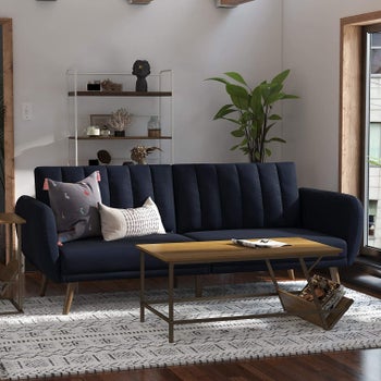 a navy blue couch with ridges in the back