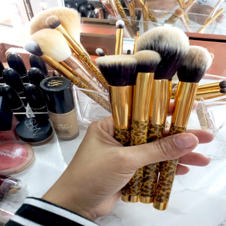 reviewer holding brushes in hand