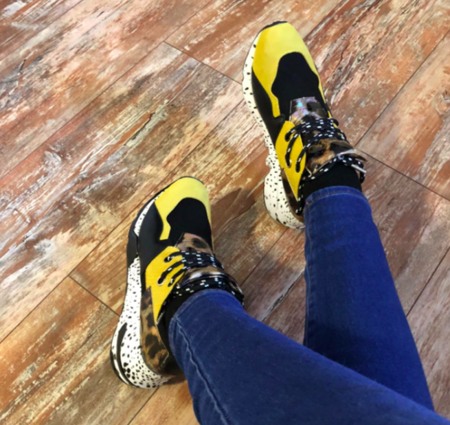 Reviewer wearing the yellow and cheetah print sneaker