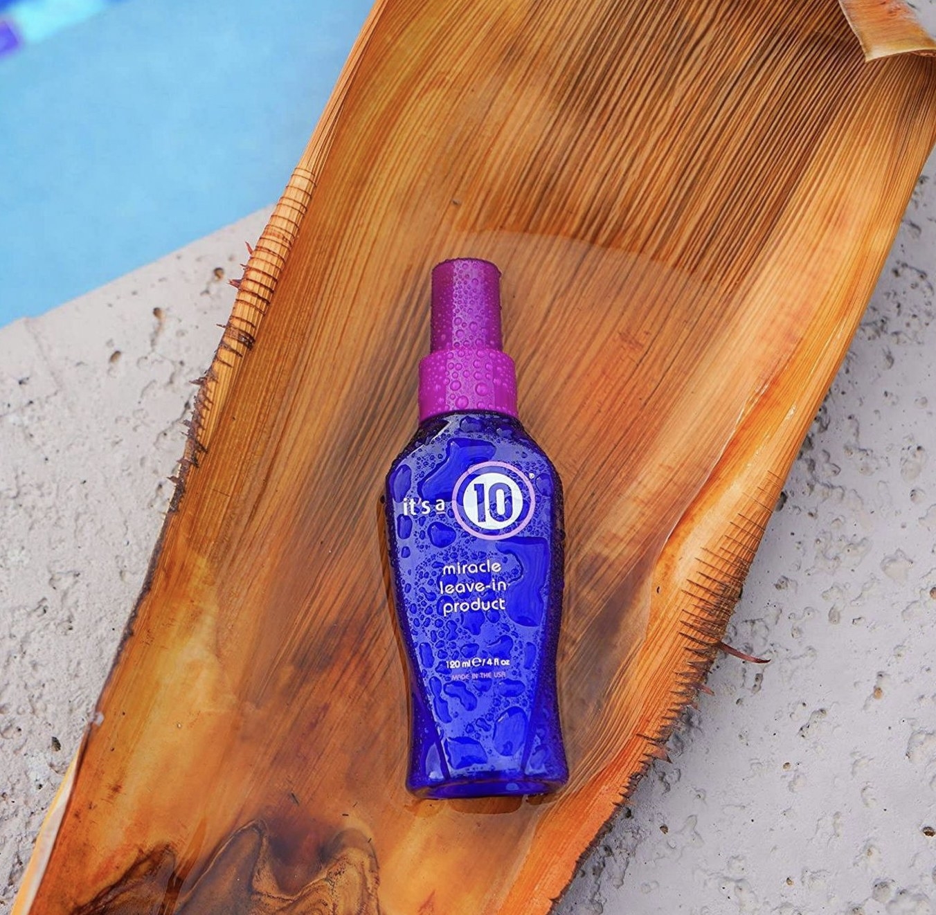A blue bottle of leave-in hair product
