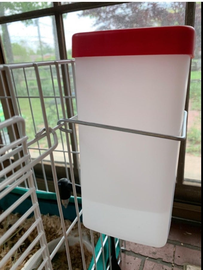 A water bottle set up in a cage for the animal