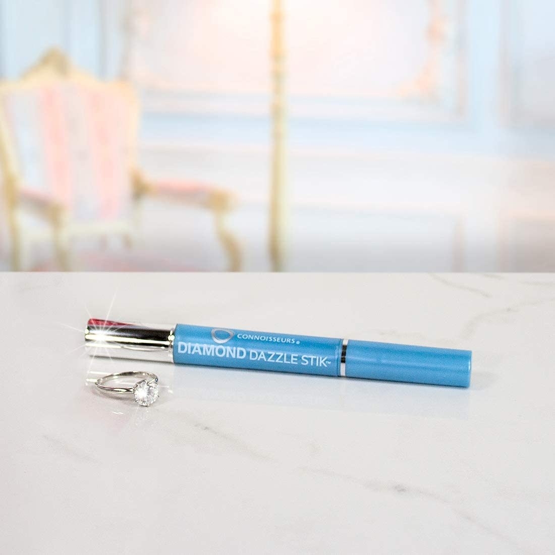 the diamond cleaning pen on a table next to a ring