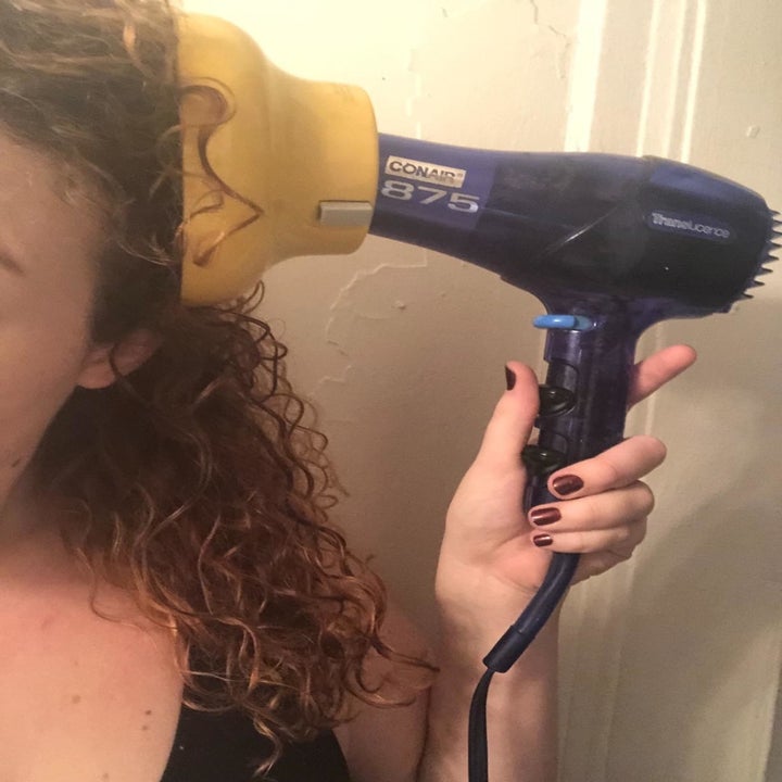 reviewer uses same diffuser on their blow dryer to dry their curly hair