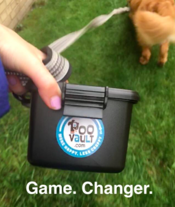 Reviewer holding the poop holder with caption &quot;game changer&quot;