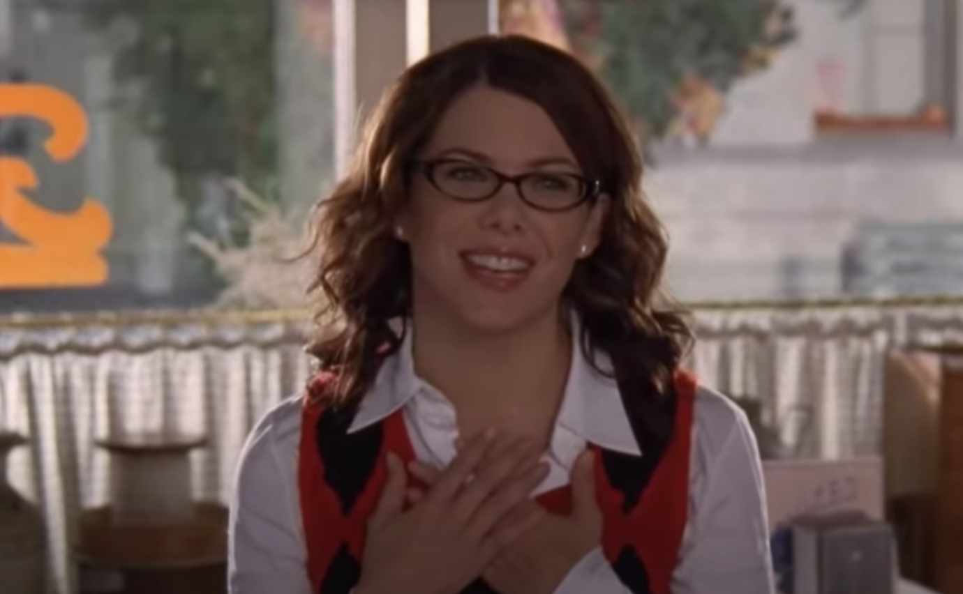 Lorelai smiling with her hands over her heart